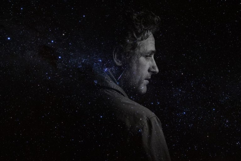 Tom Stade in profile against a starry sky