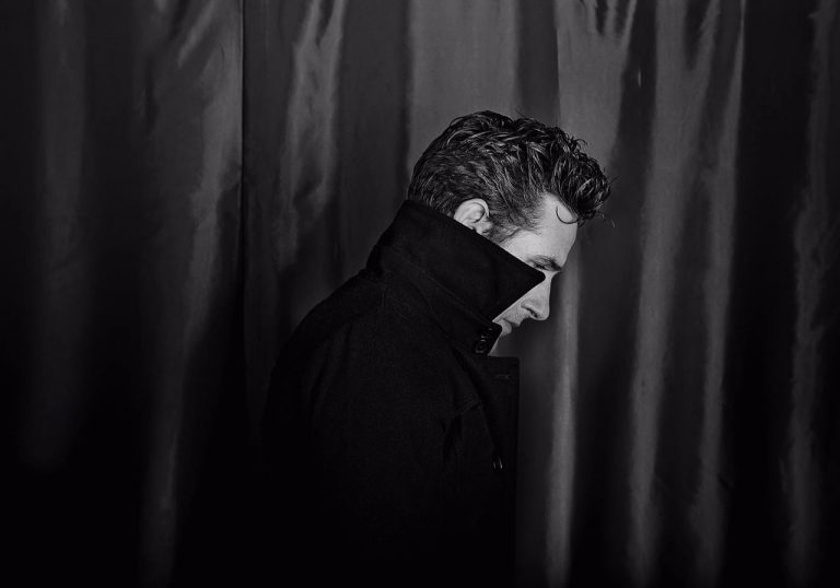 Tom Stade side profile, he is wearing his jacket collar up