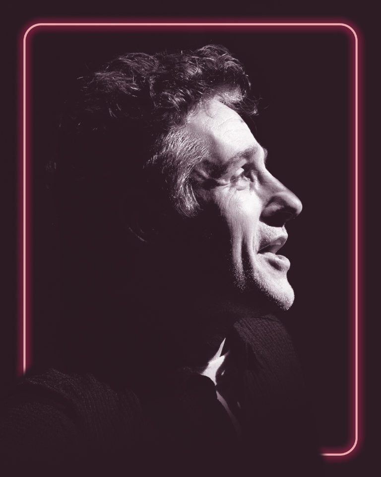 Tom Stade in profile, framed by a pink neon border